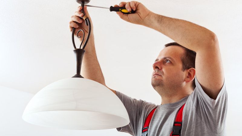 An electrician working on lights in a domestic home 