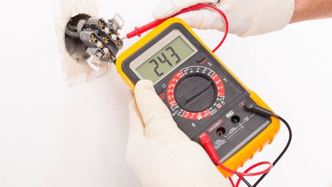 An electrician carrying out PAT testing